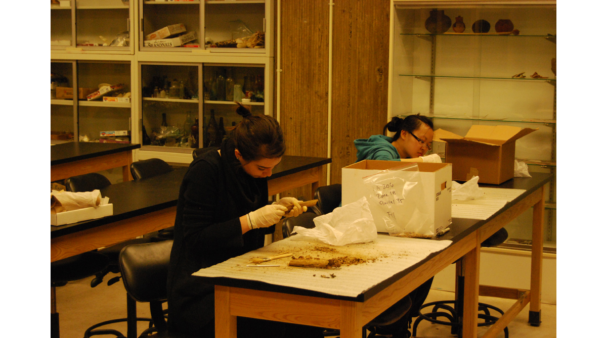 Victoria Nichols and Jade Chin cleaning skeletons.